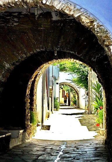 Paved alley and arches in Steni, Tinos island, Greece