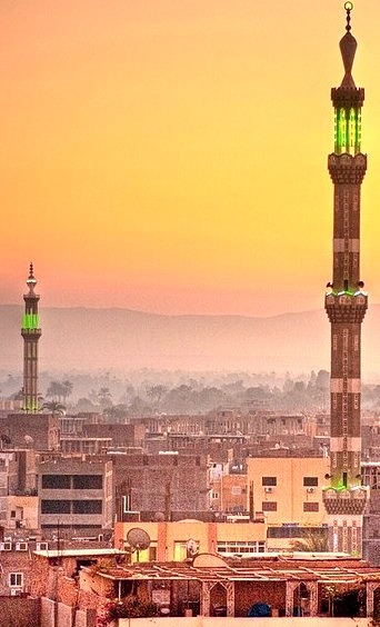 Sunset on the cityscape and the minarets of Luxor, Egypt